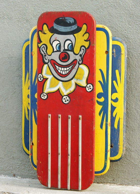 A wonderfully expressive painted clown face adorns this staggered carousel light with vibrant original red, yellow and blue park paint.