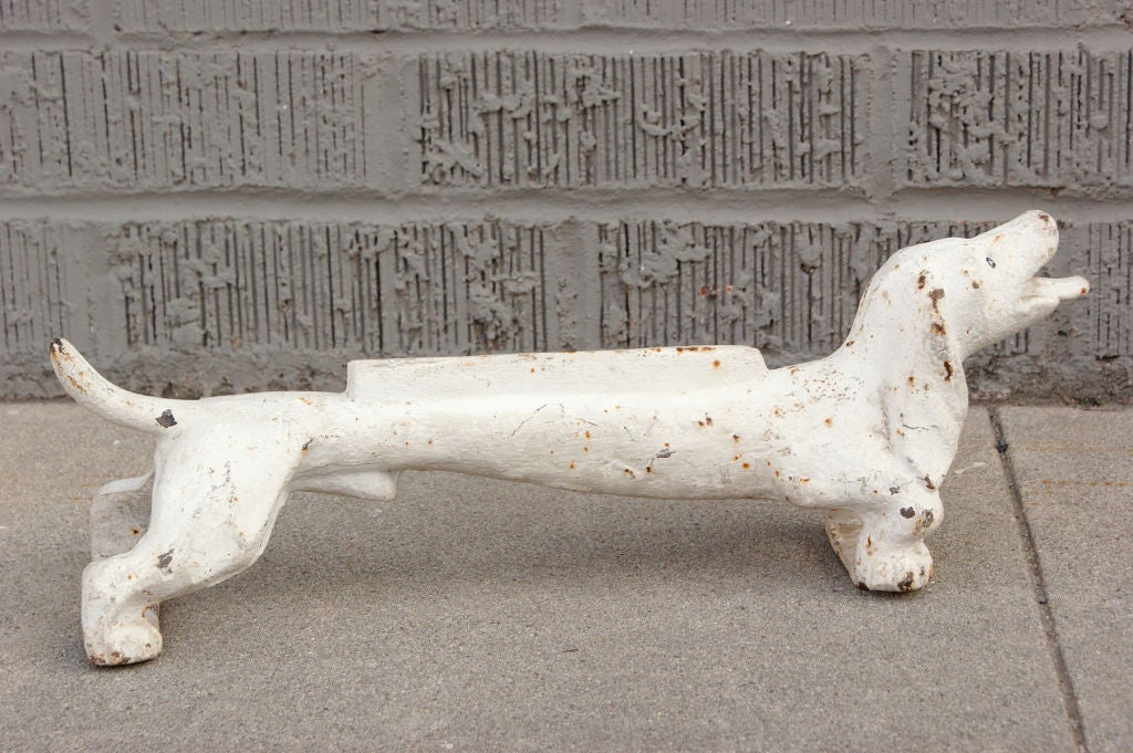 Wonderfully animated cast iron dachshund boot scrapper with original white paint surface.