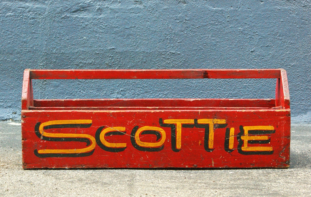 Rugged wooden tool caddy with vibrant original red paint surface and hand-painted, shadowed yellow lettering.