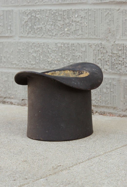Fantastic late 19th century cast iron top hat spittoon with original black paint surface.