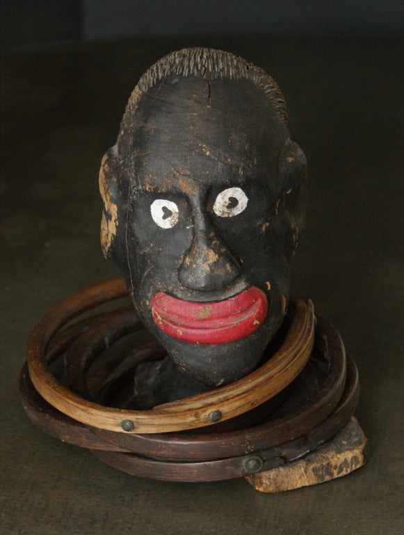 Fantastic 19th century carved wood American carnival ring toss head with five bentwood rings. Superb example of early American carnival art.