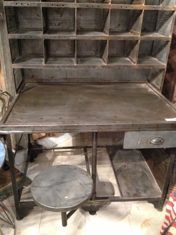 Steel antique post office desk with compartments and working swing out stool.