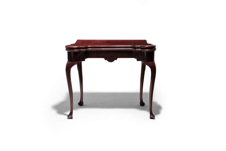 Elegant Queen Anne form is pronounced in this nicely shaped gaming table.  It has turreted corners and top, felt toplining and pockets and cabriole legs terminating in trifid feet.