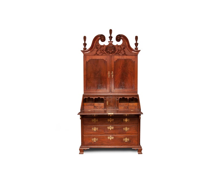 This example of Philadelphia craftsmanship demonstrates what the finer hands of this period could do.  A scrolled top with three urn and finials are all nicely complemented by vine carving surrounding a bold carved center shell make this piece a