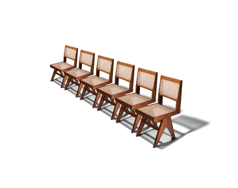 Each have a caned seat and back, V-Type flared triangular legs and stretchers. Chandigarh, India, c. 1959.  Dimensions: H 33.5-35