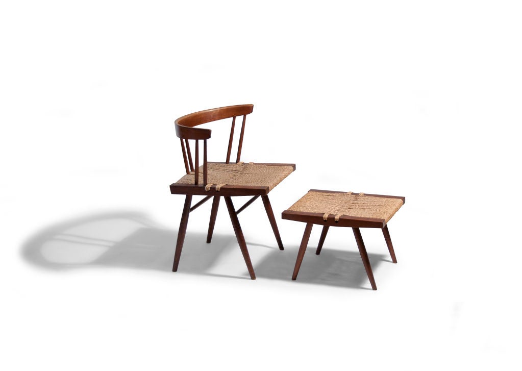 One of the more distinguishable designs from the studio of George Nakashima, this grass-seated side chair has a shaped crest rail with six flared spindles adjoined to an interwoven sea grass seat.  Four flared legs are joined by simple stretchers. 