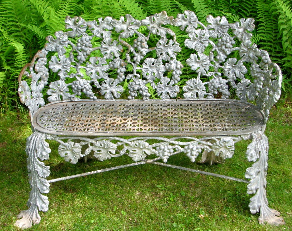 Elegant Grey Garden bench with grape leaf motif and graphic seat. America circ 1880-1900