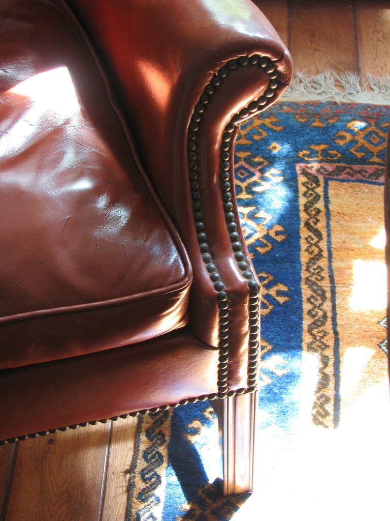 Leather Wingback Library Chair
Brass nailhead detailing and unusual deep caramel color. Very striking. Very gentlemanly in form and tone.