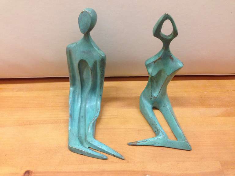 Pair of signed bronze male and female sculptures ideal for bookends.