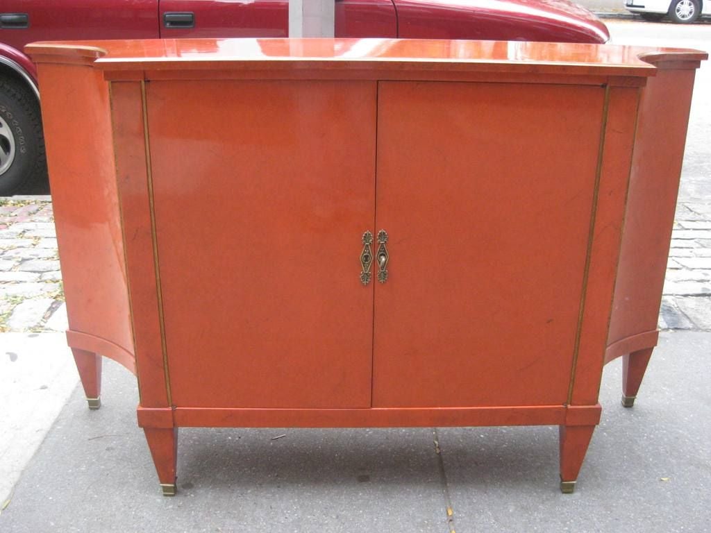 Beautiful Veined Orange Cabinet / Buffet after Maison Jansen, this Mid Century Piece with Hollywood Regency Styling and Neoclassical Elements is a Treat to the Eyes, with Single Keyed Lock for Both Doors, Brass Sabots and Gilded Convex Edge, Please