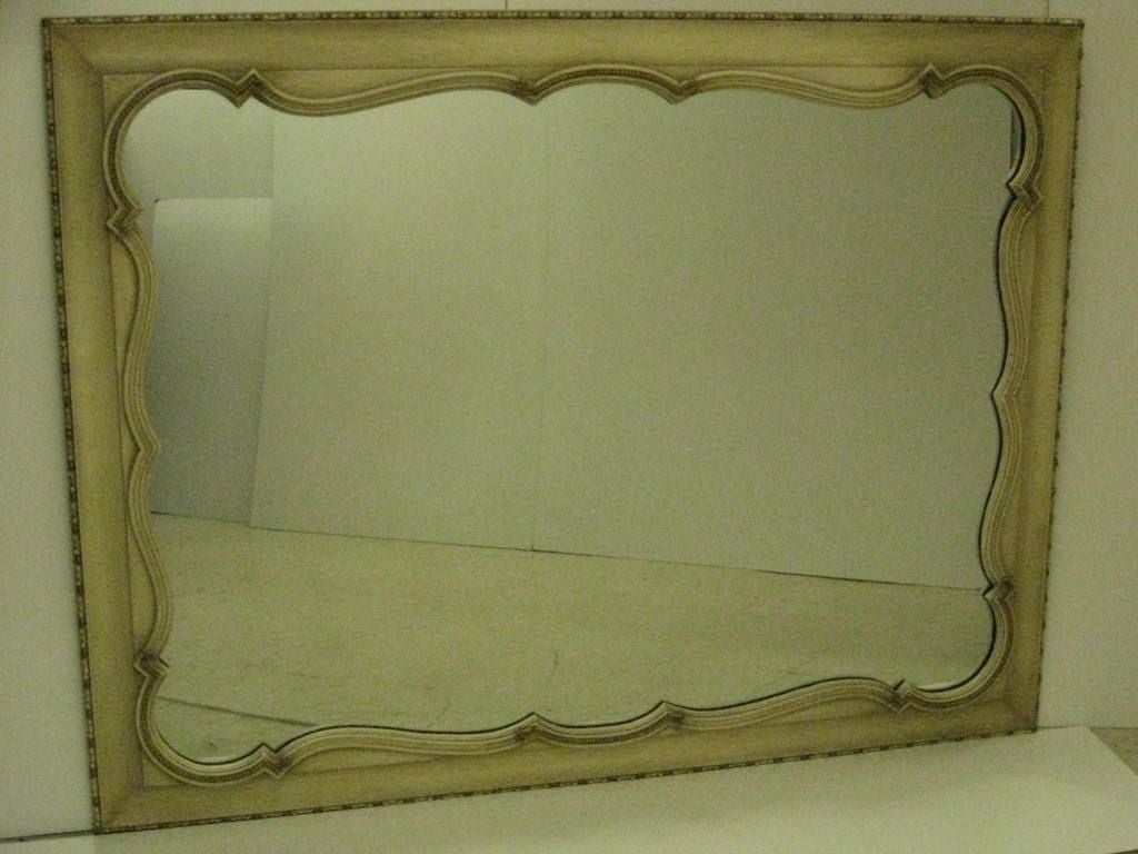 Ask about free shipping on this item, Hollywood Regency mirror, in bone color with subtle details, this item is on sale for a clearance price.