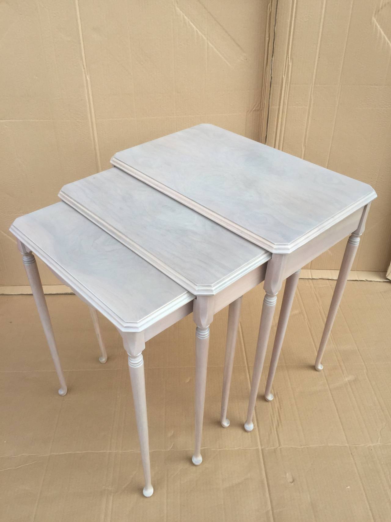 Set of three white washed golf club legs nesting tables after T.H. Robsjohn Gibbings.