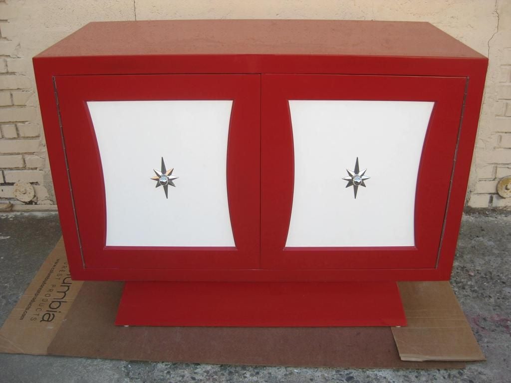 Grosfeld House style beautiful red dresser with pulls in the manner of Tommi Parzinger, Leatherette door insets which can be changed to any color.