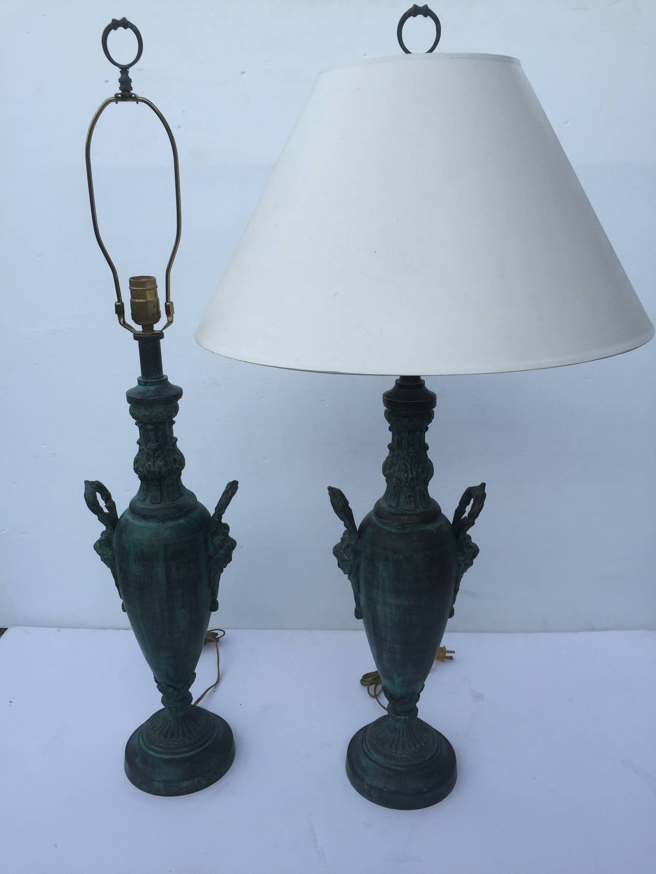 Pair of Art Nouveau Romanesque Classical Revival style solid cast brass table night lamps with original finials at 39". Shown here with 21 x 11 shade
Measures: D 8, H 25.75.