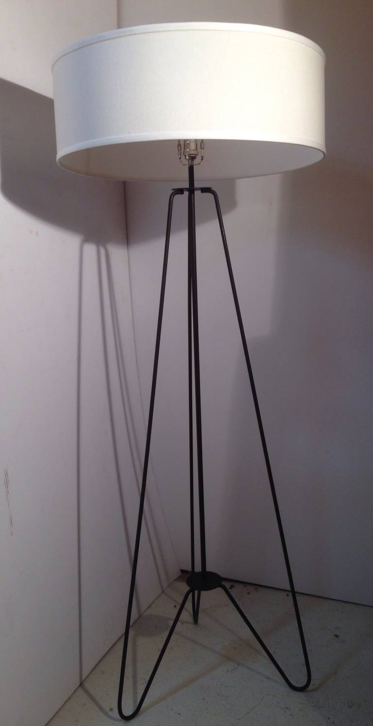 Pair of minimalist floor lamps in the manner of Jean Royere.