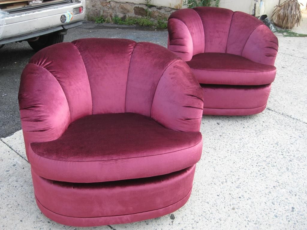Pair of plush Hollywood glamorous swivel barrel chairs.
