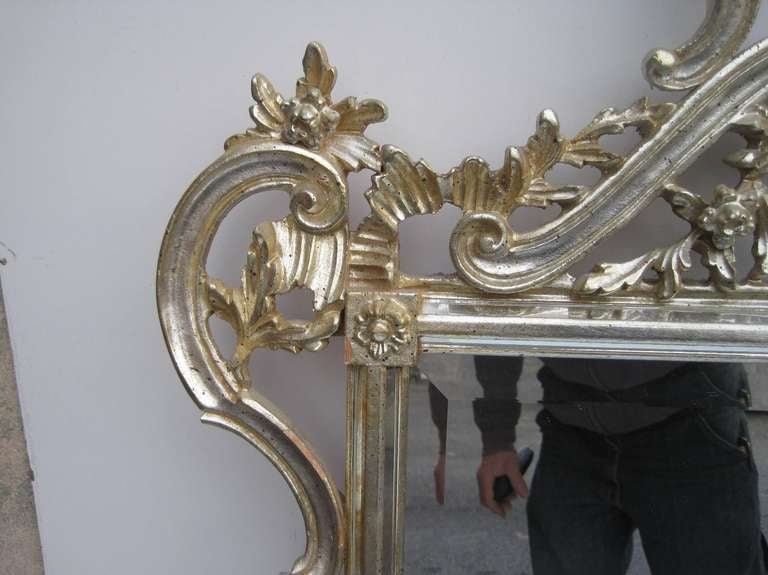 A glamorous white gold leaf accent Italian mirror, will go with any style or era decor.  