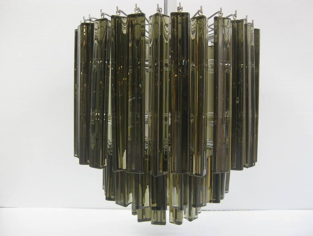 Rare Smoked Crystal Chandelier, personification of chic, accepts 11 American candelabra bulbs total of 660 Watts, 17 1/2 Chandelier body size 31