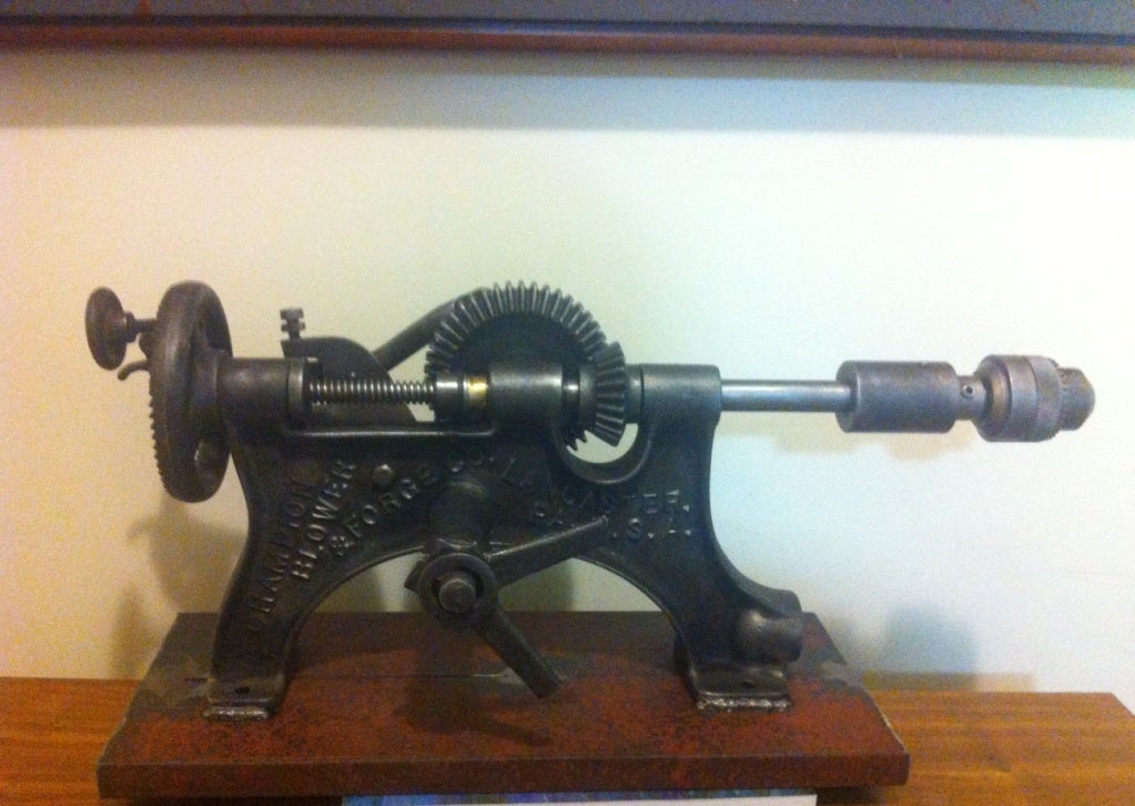 Industrial drill sculpture, from the turn of the century machine shop, probably used belts from an outside source such as a central motor, steam or gasoline engine and possibly a wind or water mill.