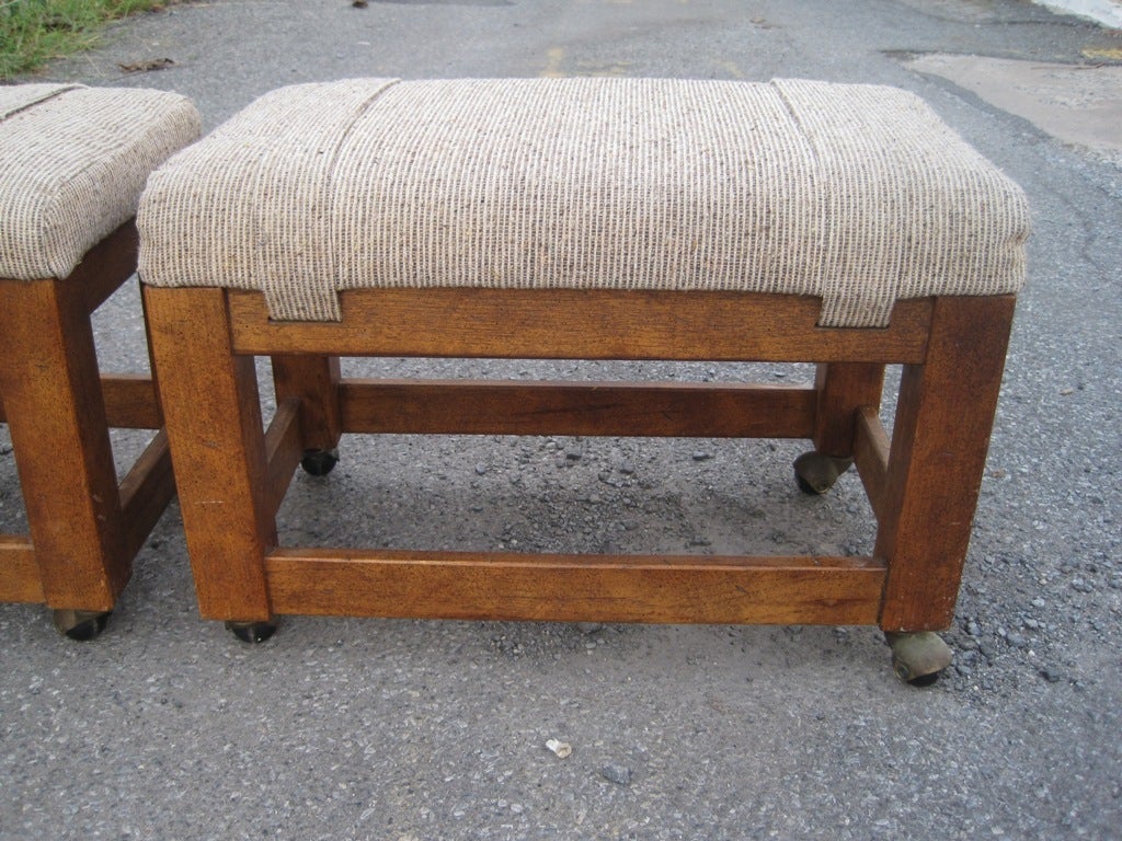 Pair of Mid-Century Modern signed mahogany rolling ottomans footstool.
Will reupholster to your specs WCOF for a minimal fee. This item is onsale now for a clearance price.