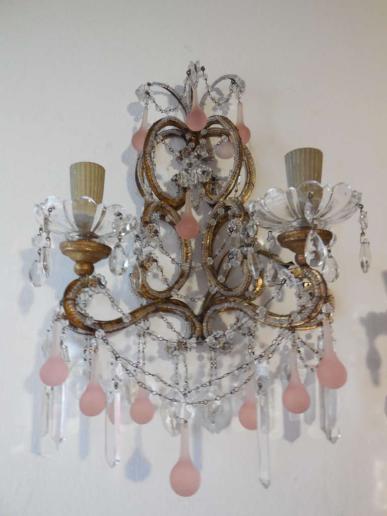 Incredible and very rare pair of stunning bubble gum murano pink drop crystal sconces..c1900 sitting on gilded metal all beaded frames housing 2 lights each with gilded gold wood cups holding crystal hand blown bobeches dripping with clear prisms