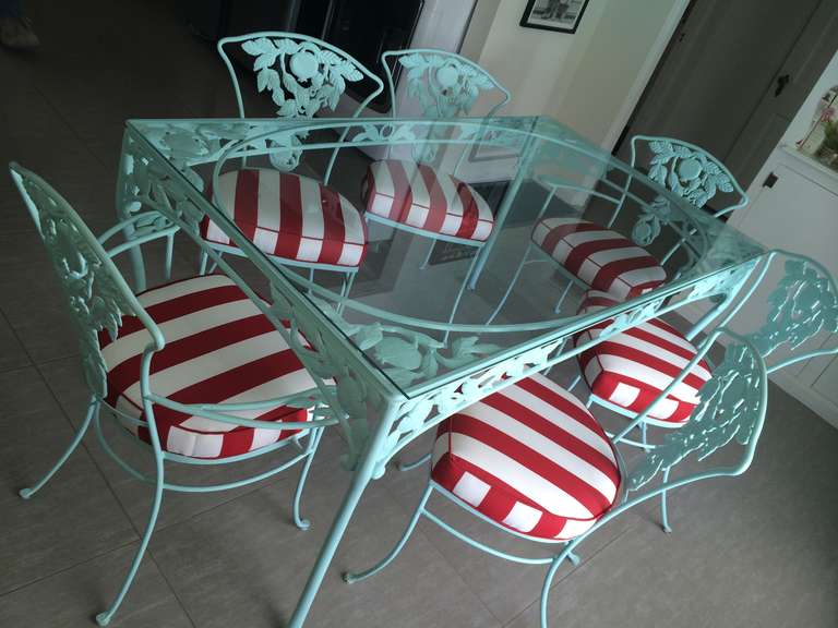 Gorgeous vintage Woodard pomegranate glass top turquoise patio set.Includes 2 arm end chairs and 4 armless side chairs newly covered in inside out Sunbrella red and white stripe fabric.The pomegranate pattern was the most popular design Woodard did~