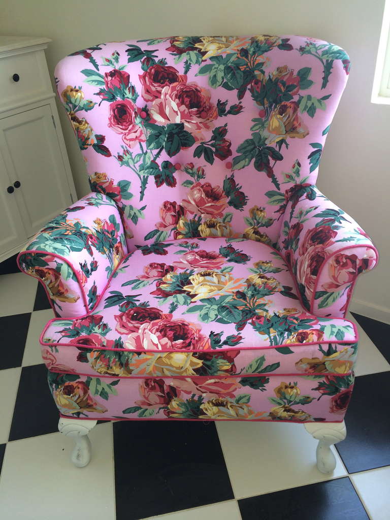 Stunning cabbage rose club chair redone in the most crazy amazing hot pink vintage cabbage rose fabric tufted back in a darker rose fabric white legs.
