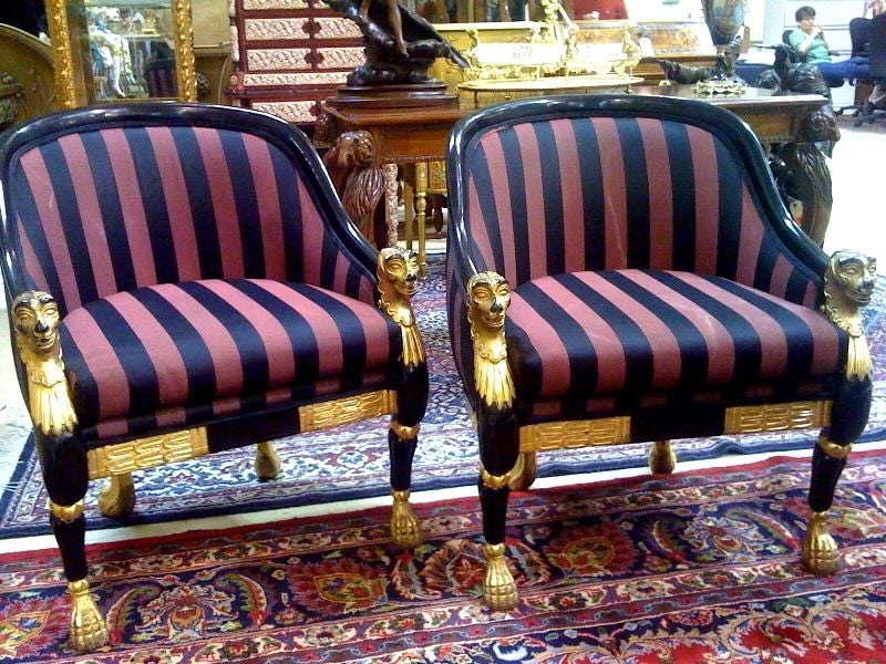 Pair of FABULOUS directoire style armchairs out of Liberaces Las Vegas estate~<br />
They are amazing! Origional black lacquer finish,origional black and plum fabric, gold trim with these wonderful heads on each arm with gold feet!<br />
2 die 4!!!