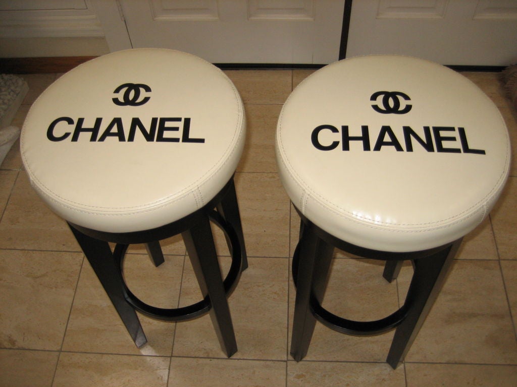 A Fantastic find...Very collectable pair of CHANEL stools from the early 80's.Came out of CHANEL boutique Bullocks Wilshire downtown LA when they closed...Creamy colored leather,black vinyl covered letters on stools.Black laquered very firm
