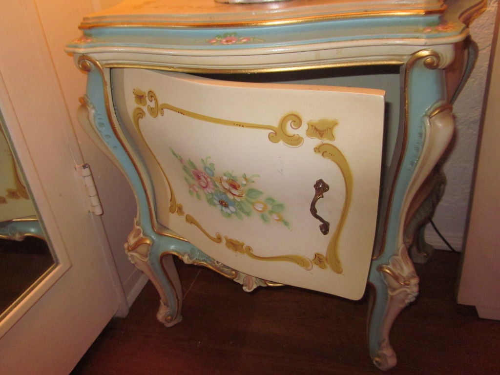 A pair of delicious floral side tables.Very ornate with gilding,pinks,greens,yellows and a fabulous blue detail.<br />
Their is also a matching bed,double dresser,mirror and armoire that go with~