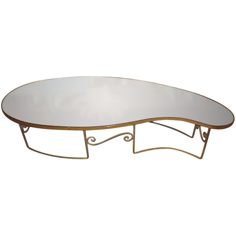 A Fabulous Mid Century mirror tear drop shape coffee table with original gold gilded iron patina base...