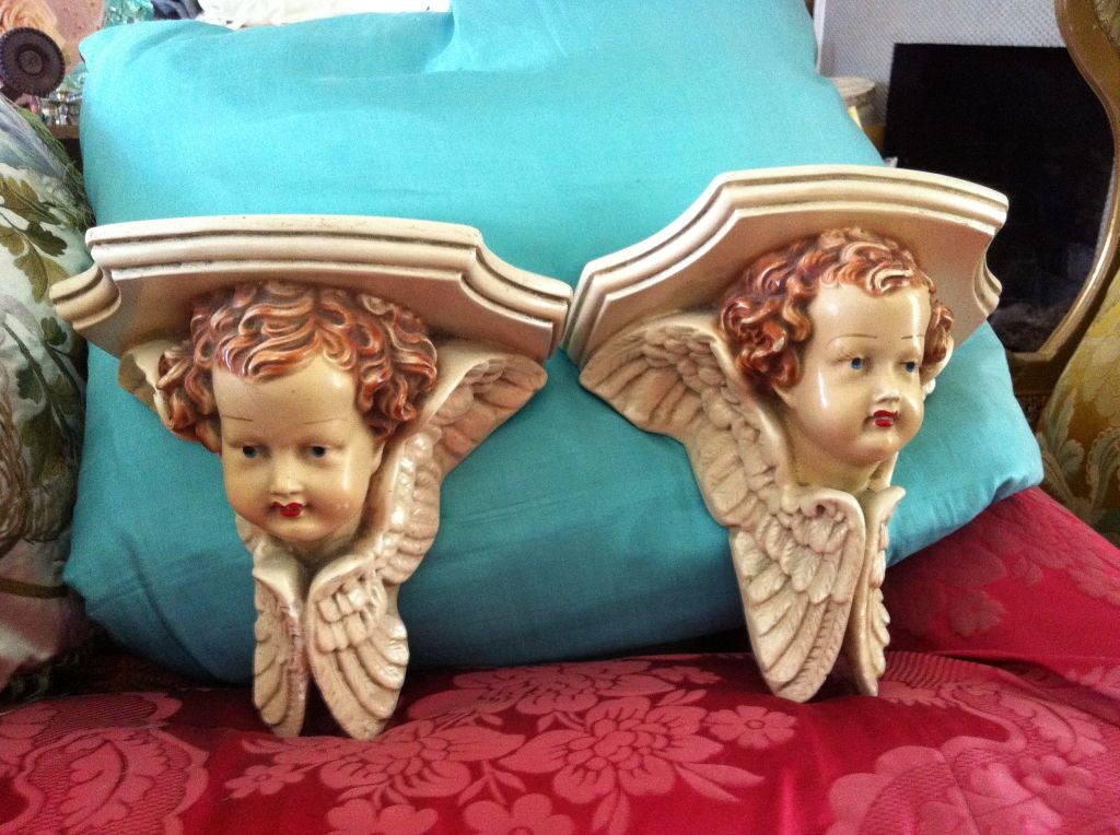A wonderful whimsical pair of vintage cherub corbel wall decorations...