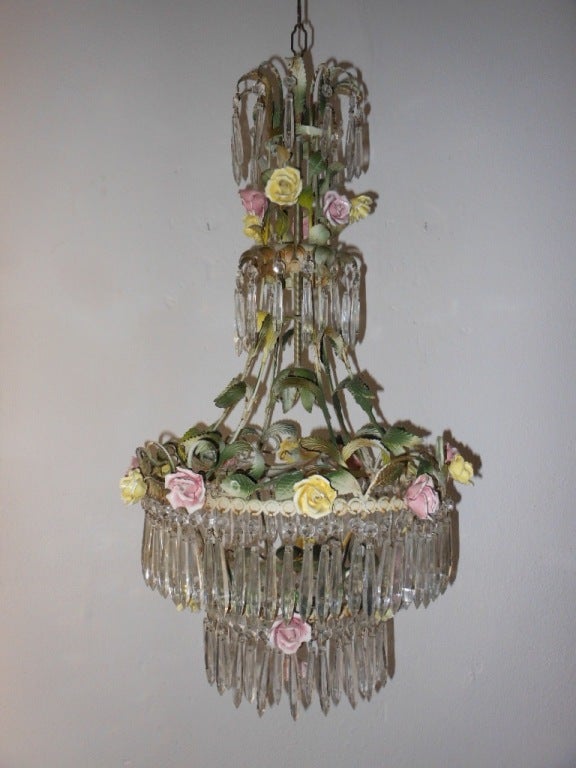 Gorgeous pink and yellow rose Chandelier...
Picked up in the South of France. Frame has 4 tiers cascading and dripping with over 100 hand made cut crystals and hand made porcelain pink and yellow roses with amazing green tole leaves.All original