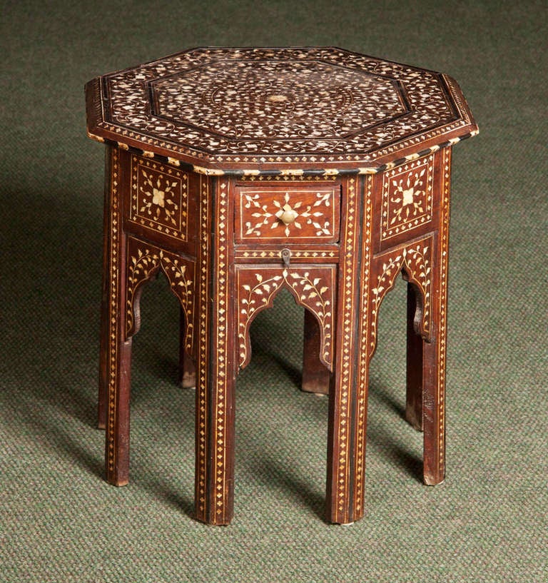 A middle eastern, octagonal late 19th/early 20th century bone inlaid low end table.  A second near-matching table is also available.