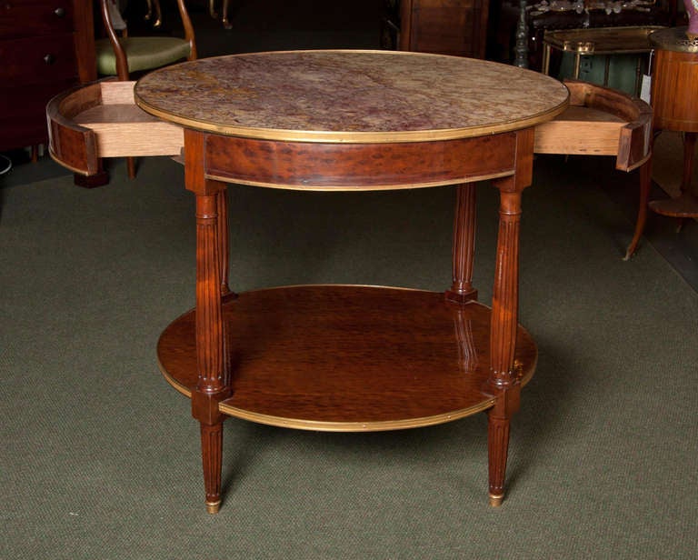 A French late 19th century plum pudding mahogany brass-mounted Bouillotte table with a breche violette marble top. Stamped to underside: Escalier de Cristal.