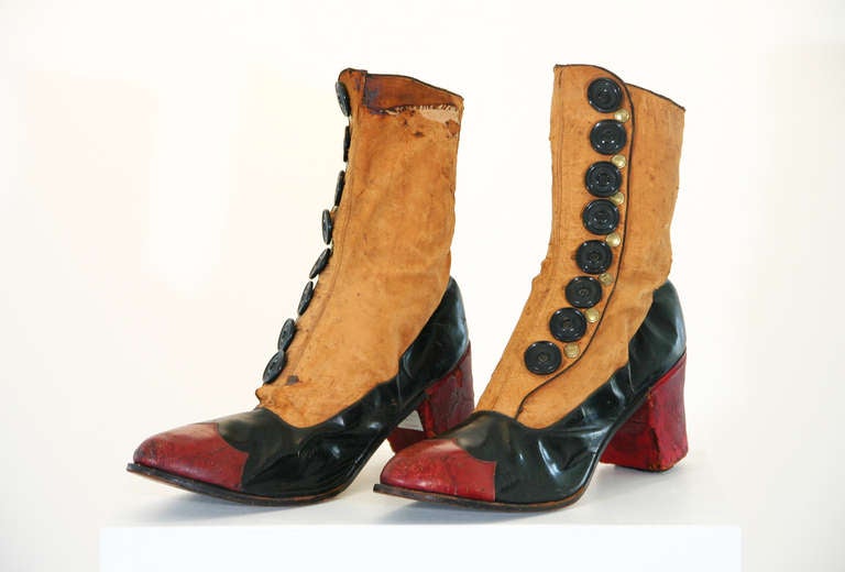 Pair of Late 19th Century Victorian Oversized Shoes from a shoe shop window display; the soles and uppers leather, with kid ankles, decorated with buttons and greek key etched brass studs.