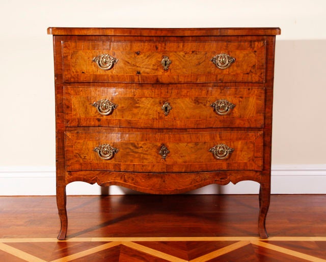 A mid-18th century walnut boxwood line inlaid commode with serpentine front and sides.