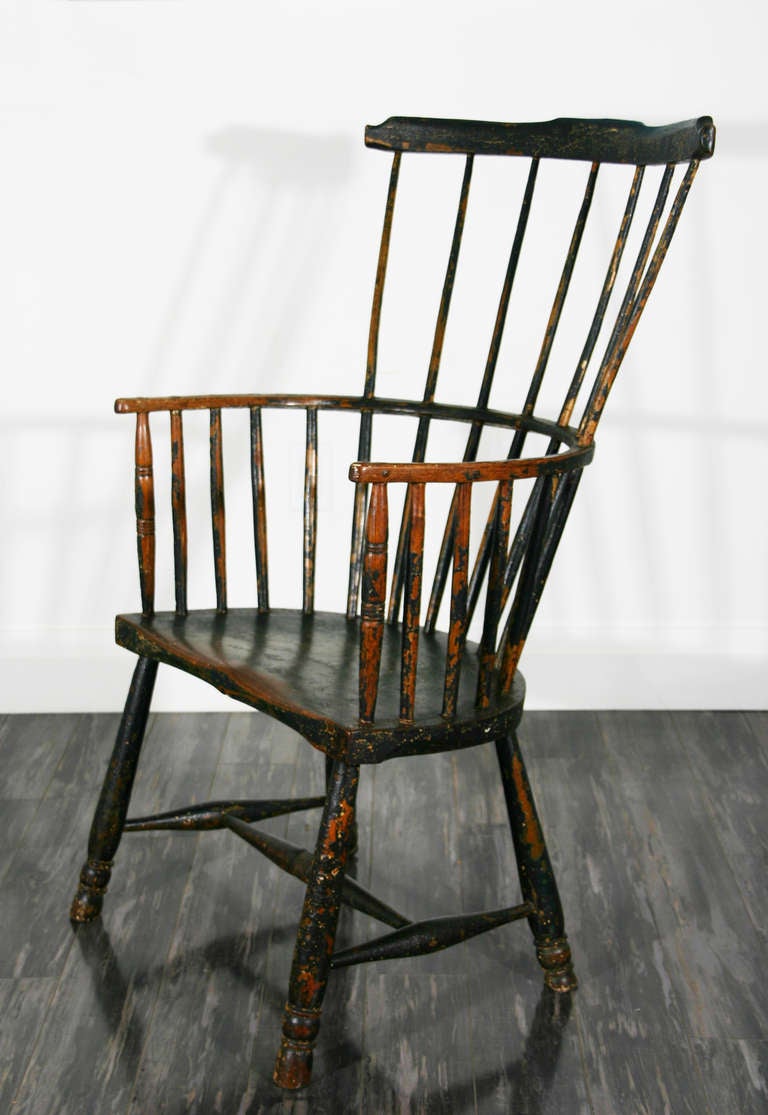 A late 18th century comb back Windsor armchair with original green paint