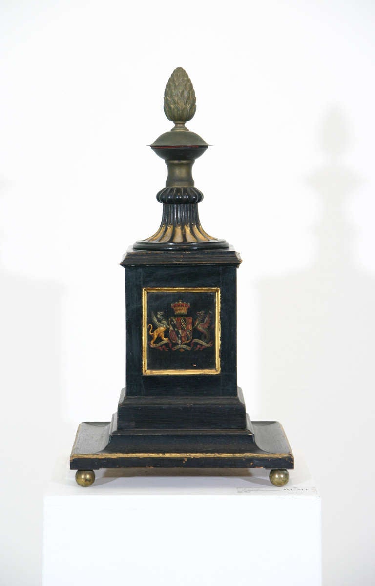 An English early 19th century Regency period painted and parcel-gilt newel post. Each side with an individual painting including a coat of arms, a dragon and an ostrich; the carved, fluted top terminating in an acorn finial. Now raised on gilded