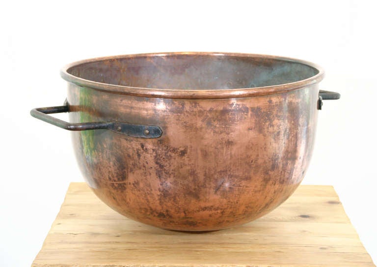 A Mid. 19th century Copper Cauldron with iron lifting handles and rounded bottom.  Nice old patina.