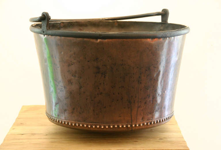 An Early 19th Century Riveted Copper Apple Butter Cauldron with forged iron handle.