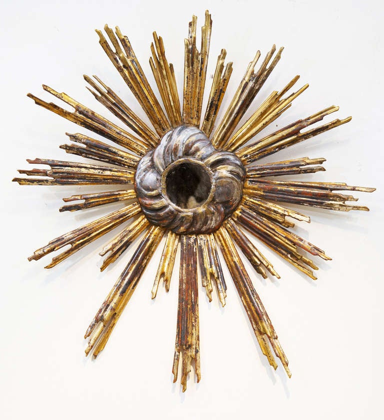A special and rare gold gilt sunburst mirror with hand carved 
wood construction and silver 