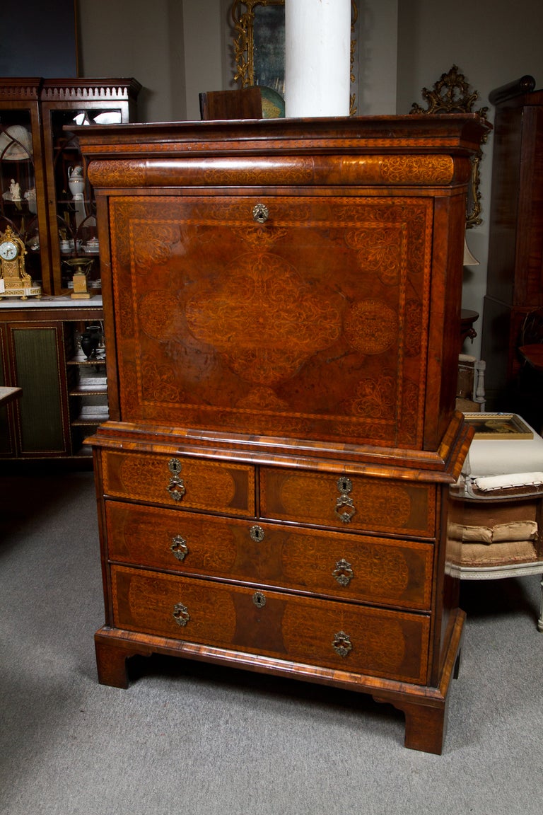 Rare Queen Anne walnut and seaweed marquetry escritoire. This beautiful fall-front secretaire on chest opens to reveal a fitted interior and leather writing surface. The entire case is covered in beautifully matched burled walnut veneer, finely