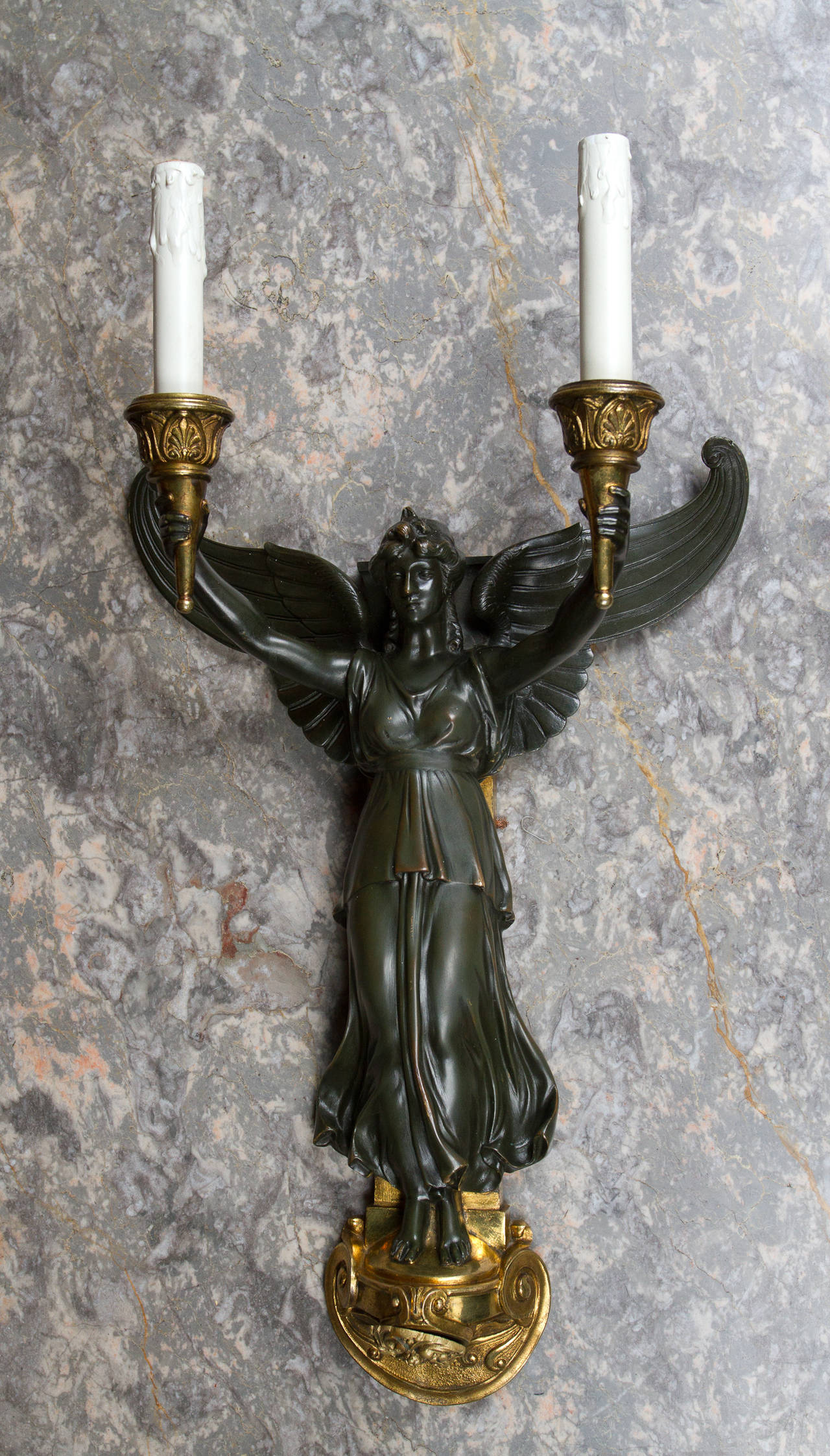 Empire style gilt and patinated bronze single, two-light sconce representing winged victory.