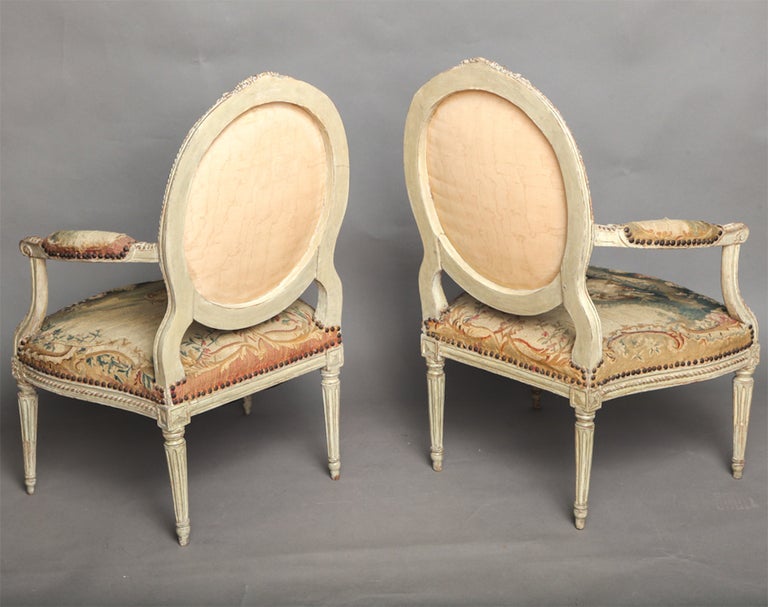 Very fine pair of 18th Century French Louis XVI armchairs, the oval backs having foliate carved crests, over scrolled arms, over bow fronted seat, the rails with foliate and rope twist carving, standing on turned, fluted and stop fluted legs