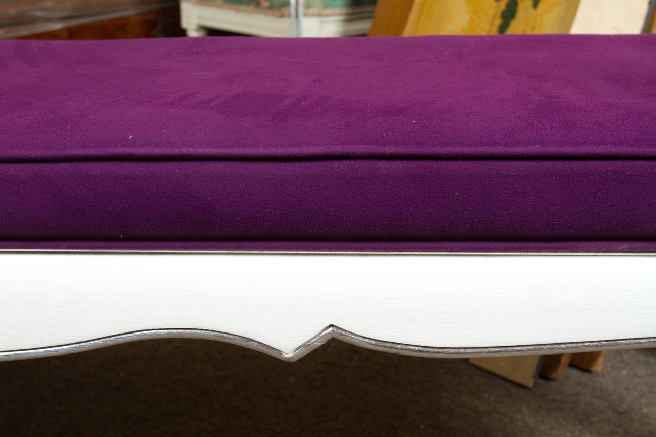 Elegant white painted and silver gilt Louis XV style bench upholstered in a vibrant purple fabric.