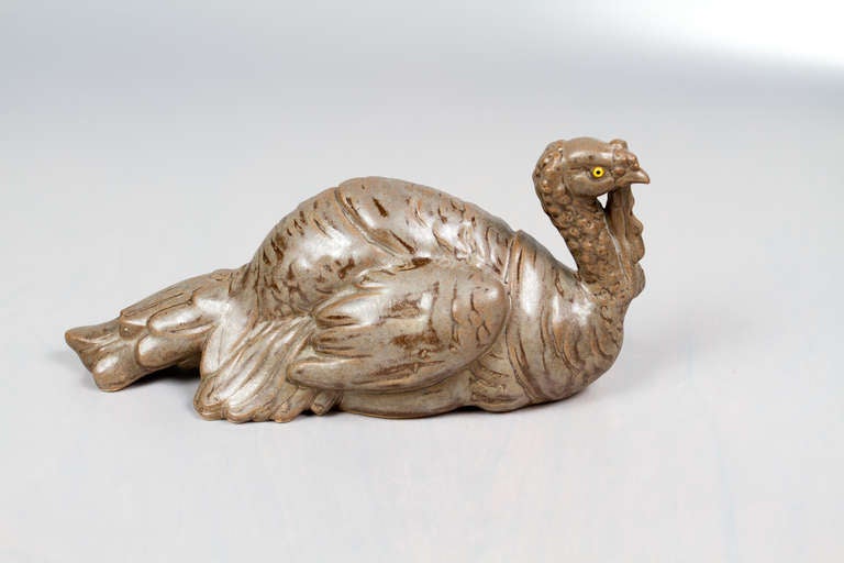 Interesting ceramic sculpture of a wild turkey with brown glazing and glass eyes.
Illegeble signature.