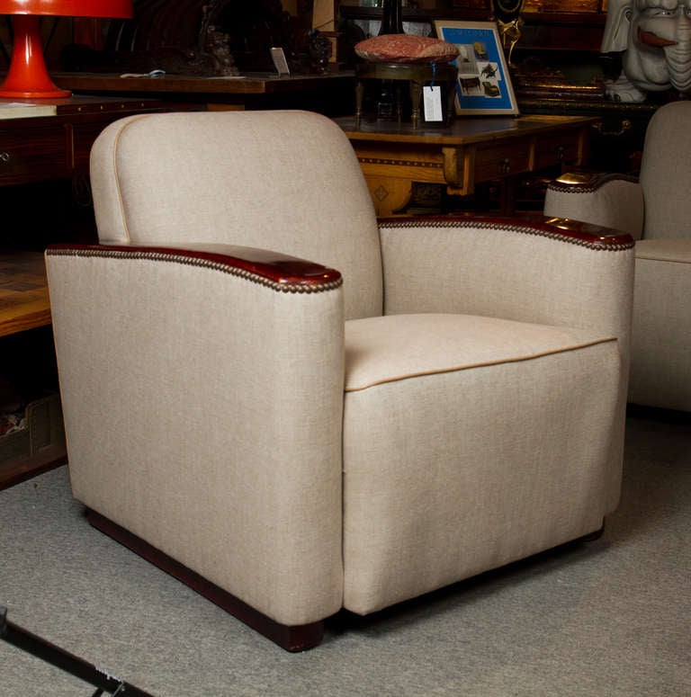 Stylish pair of upholstered Art Deco club chairs with cherry-wood trim, in the manner of Paul Frankl.