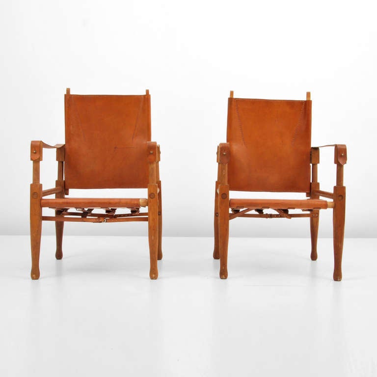 Rare pair of Wilhelm Kienzle and Wohnbedarf safari chairs. Beautifully patinated stitched leather and beechwood construction.