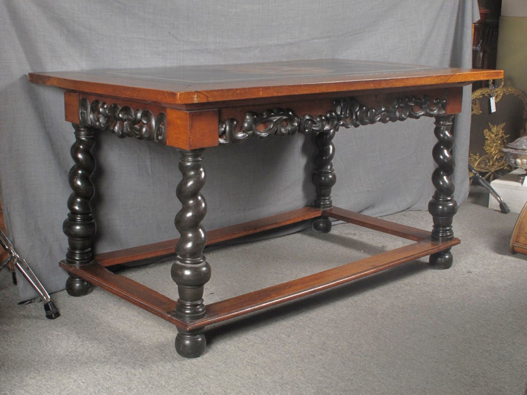North Italian or South German walnut side table with scagliola marble armorial top with ebonized turned feet and baroque relief carving. Bearing castle inventory seal.